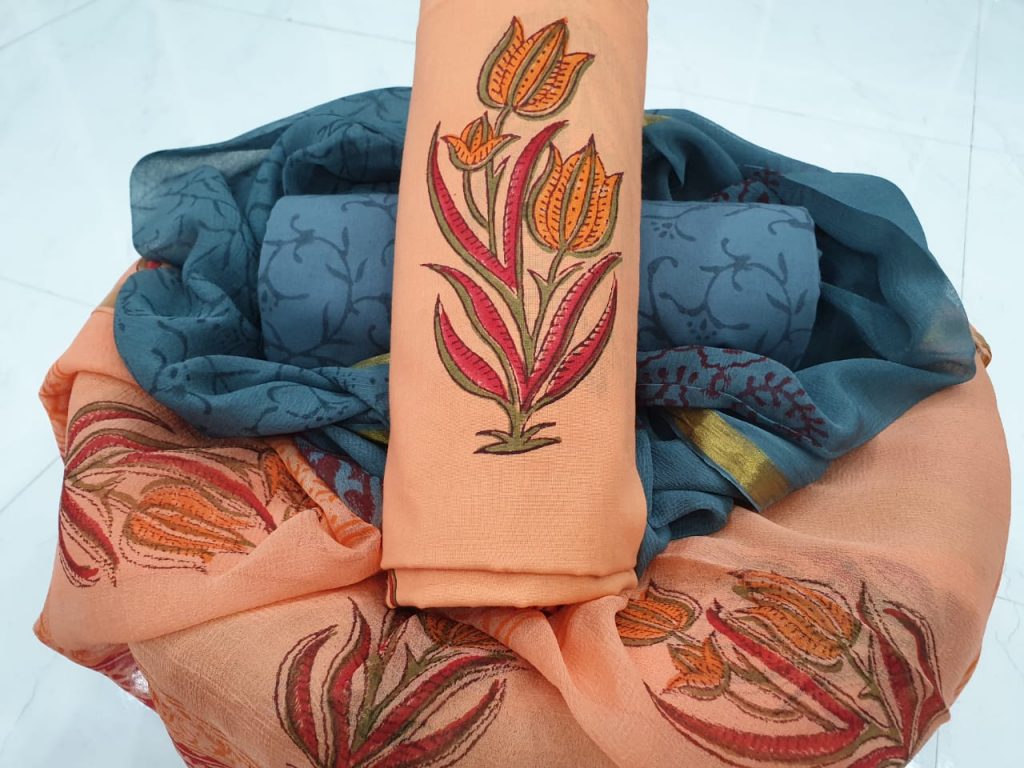 Mughal print zari border suit in salmon orange color