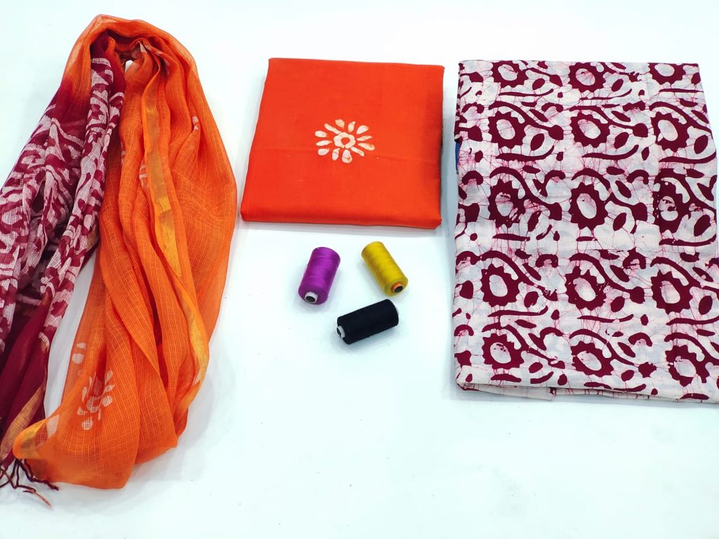 Orange and maroon batik print cotton suit with kota doriya dupatta