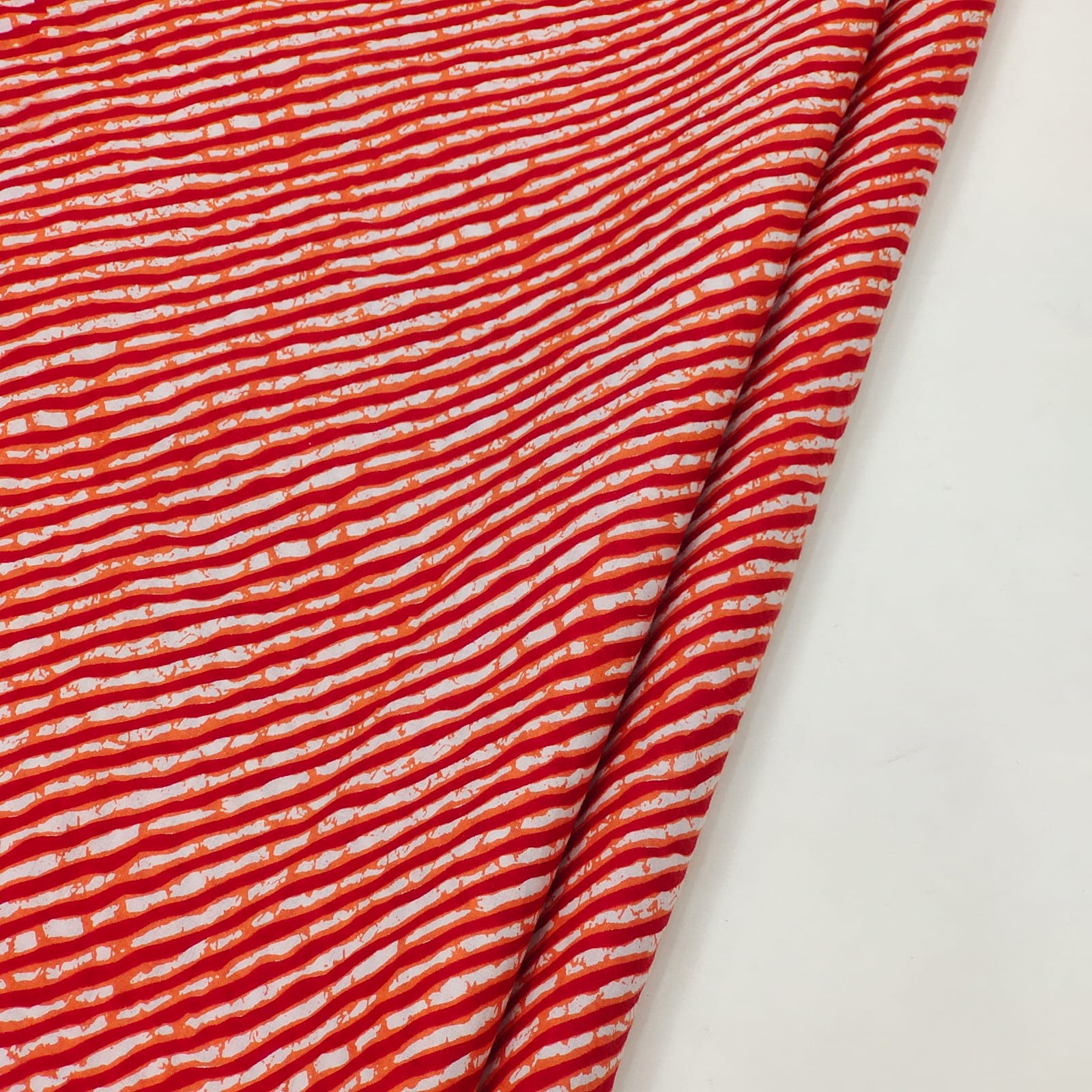 Reddish orange lehariya print cotton running material